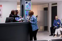 Preview: African american woman signing checkup papers