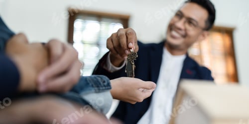Preview: Happy real state agent giving new house key to a young couple. Real estate concept