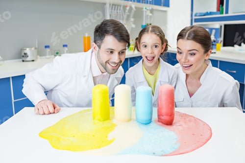 Preview: portrait of cheerful teachers and girl student scientists making experiment in lab