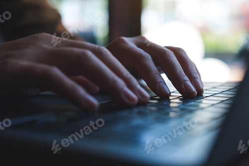 Preview: Closeup image of hands working and typing on laptop computer keyboard