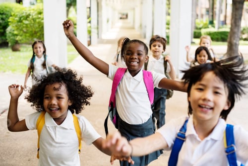 Preview: Group of diverse kindergarten students running cheerful after sc