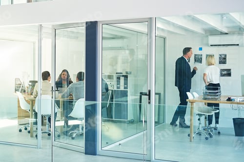 Preview: Success is the product of teamwork. Shot of corporate colleagues working together in their office.