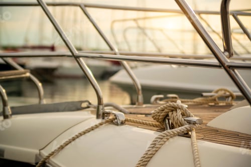 Preview: White mooring rope tied around steel anchor on boat