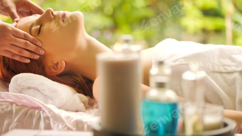 Preview: Beautiful caucasian woman getting head massage at spa.
