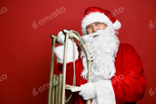 Preview: Caucasian Santa Claus with sled on red background
