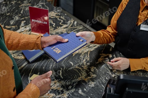 Preview: Woman Handing Book to Black Man at Counter