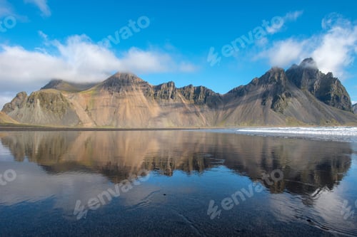 Preview: Reflection of Vestrahorn mountain in the waters of the Atlantic ocean. Stokksnes, Hofn, Iceland