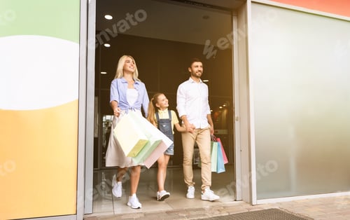 Preview: Family Leaving Hypermarket Carrying Colorful Shopper Bags