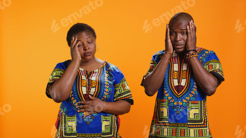 Preview: Stressed man and woman dealing with headache in studio