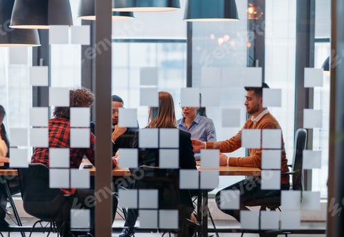 Preview: In a sleek glass office space, a team of business professionals engage in lively discussions and