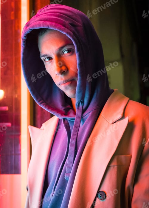 Preview: Young millennial hispanic man with red neon light reflection
