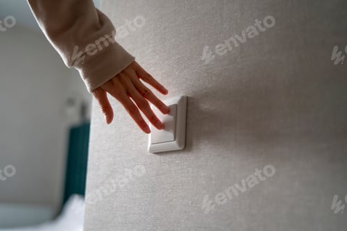 Preview: Hand Turning on a Light Switch, Illuminating a Room With the Flick of a Finger