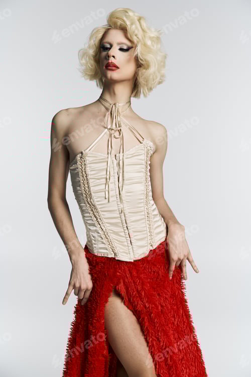 Blonde drag queen poses in red skirt and corset