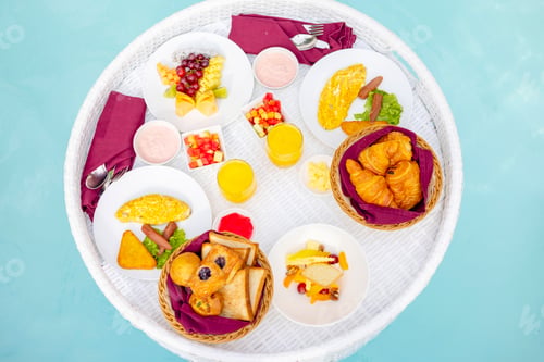 Preview: served floating tray in swimming pool with drinks and snacks on tropical island resort in Maldives