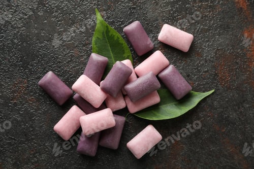 Preview: Chewing or bubble gum on dark textured background