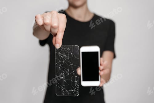 Preview: Woman hands holding broken screen protection and saved smartphone