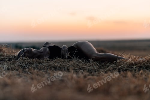 Preview: Carefree woman liying in the sunset