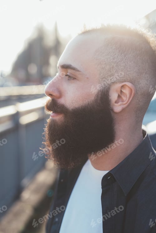 Preview: Side view portrait of bearded man looking away