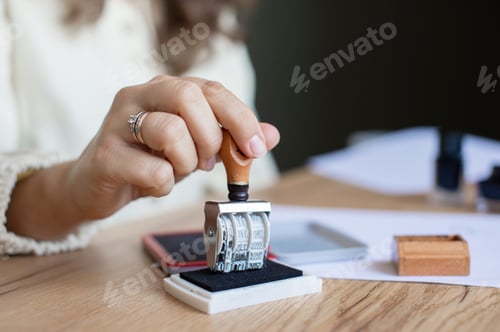Preview: Woman Stamping Document in Office Setting