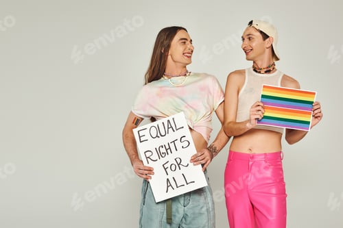 Preview: positive and tattooed lgbt people holding rainbow flag picture and placard with equal rights