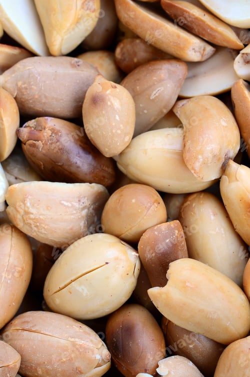 Preview: Peanut. A lot of small yellow nuts without peel. Background texture