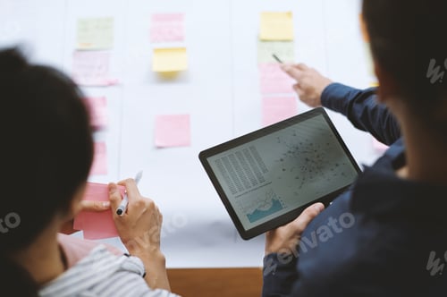 Preview: Colleagues Discussing Chart in Meeting