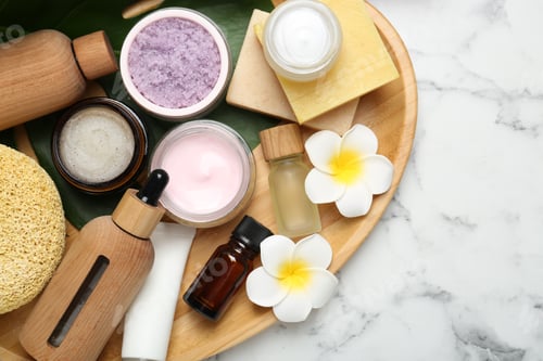 Preview: Different body care products and flowers on white marble table, top view. Space for text