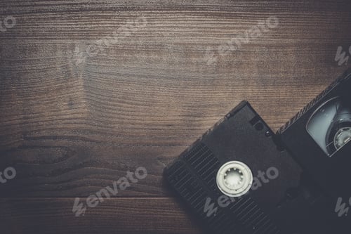 Preview: old retro video tape over wooden background