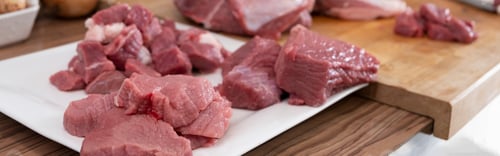 Preview: Close up of peases of meat, cutting fresh raw meat kitchen. Preparing pork meat, cooking. Banner