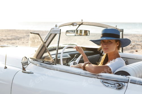 Preview: Happy young woman and retro convertible car
