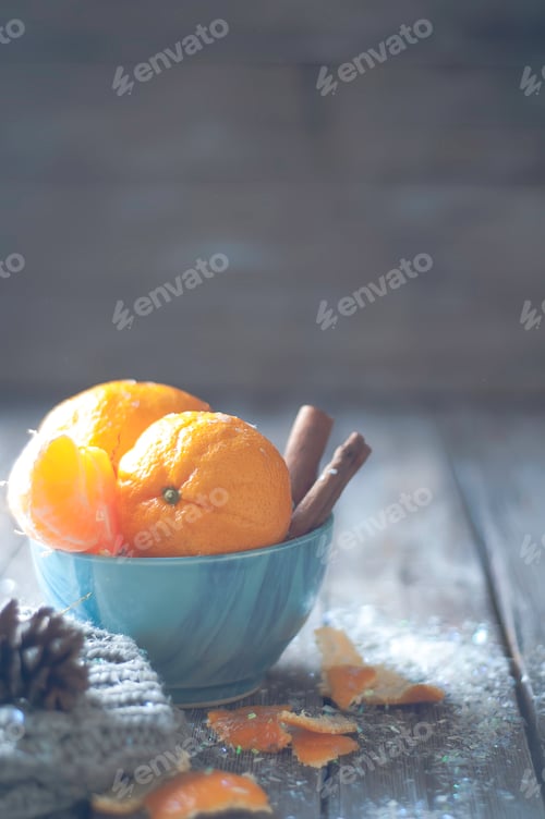 Preview: Tangerine in scarf over wooden background