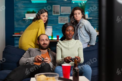 Preview: African woman and multi ethnic friends playing video games