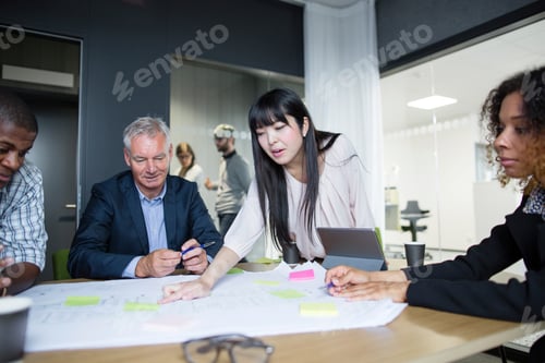 Preview: A diverse team collaboratively working on a project in a modern office setting.