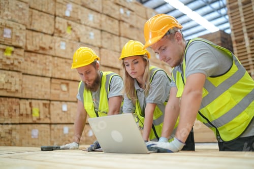Preview: Warehouse worker working on planks of wood in wooden manufacturing