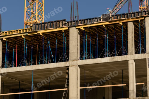 Preview: construction site with crane and building in background. yellow colored crane is in center of stage.