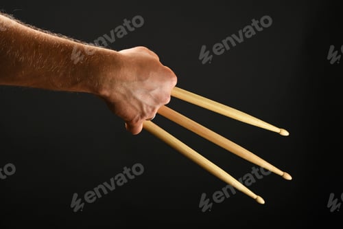 Preview: Wolverine hand with three drumsticks over black