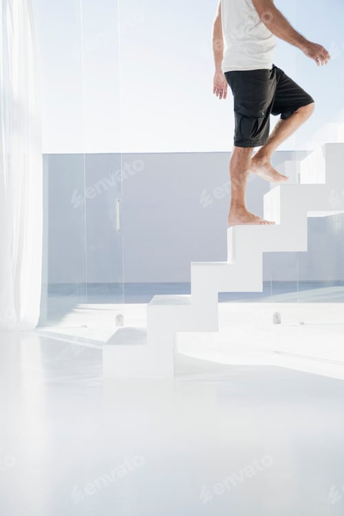 Preview: Spain, Mid adult man walking up stairway