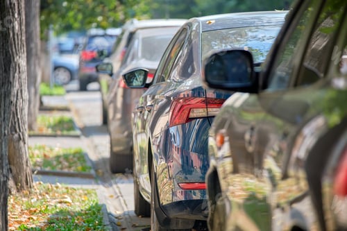 Preview: City traffic with cars parked in line on street side