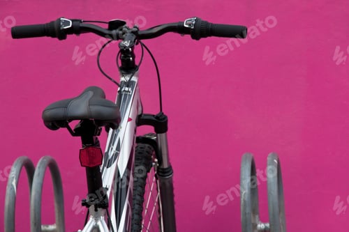 Preview: bicycle in front of the pink wall background