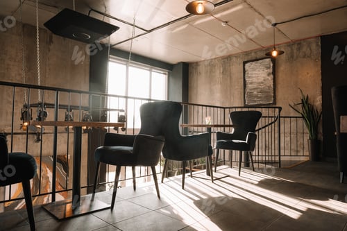 Preview: balcony with tables and chairs in modern loft coffee house in sunlight