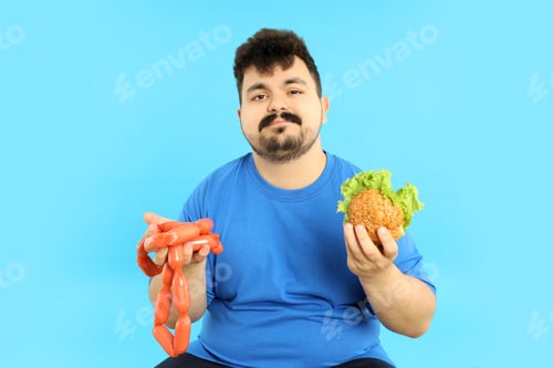 Preview: Concept of weight problems, young fat man on blue background