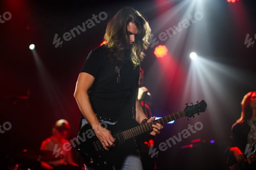 Preview: Guitarist performing live on stage with bandmates