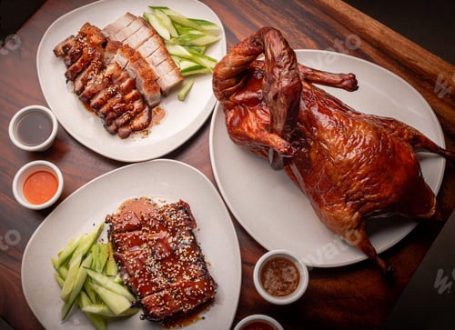 Preview: Peking duck and roasted pork served with sauces and fresh cucumbers