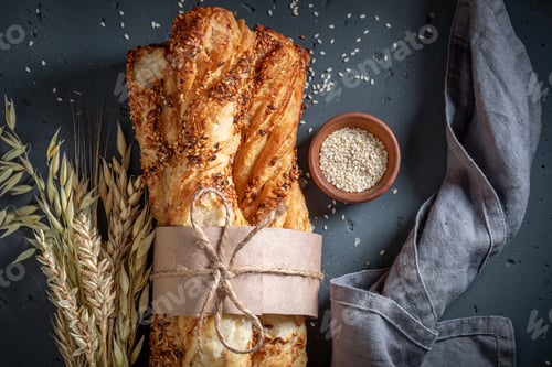 Preview: Golden bread sticks with grains and sesame seeds.