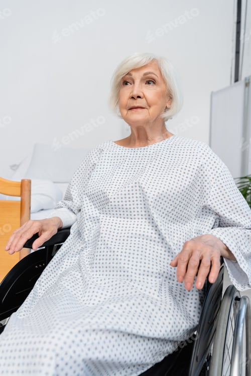 Preview: Elderly patient sitting in wheelchair in hospital ward