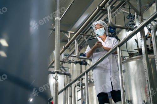 Preview: A food factory researcher inspecting canned food conveyor belt machine.