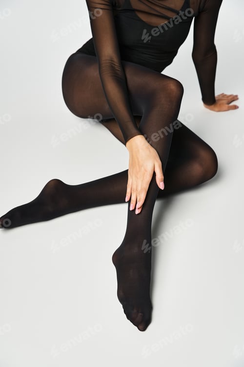 Preview: Sultry sensation: woman in black bodysuit and stockings