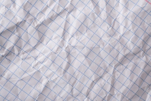 Preview: Crumpled white paper with blue grid lines provides textured background