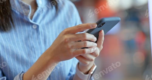 Preview: Close up of woman use of mobile phone inside shopping center