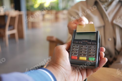 Preview: Payment process in a modern cafe during the afternoon